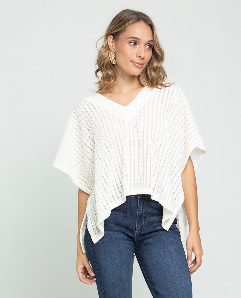 WOMEN'S KNITTED PONCHO WITH V-NECK IN FABRIC WITH A UNEMBROIDERED EFFECT
