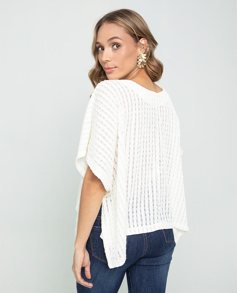 WOMEN'S KNITTED PONCHO WITH V-NECK IN FABRIC WITH A UNEMBROIDERED EFFECT